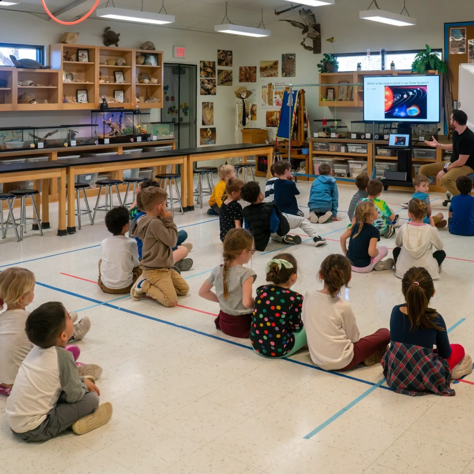 Young Benchmark students learning together among the Living Science Lab's animal habitats and displays